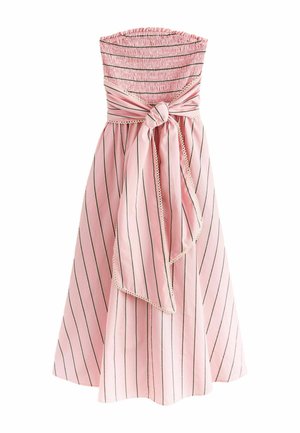 Strapless pink dress with thin vertical black stripes, a smocked bodice, and a large tied bow at the waist with scalloped edges.