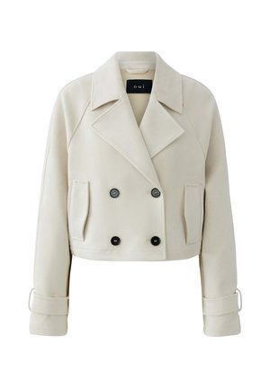 Gekürzte beige Doppelreiher-Jacke mit breiten Revers, zwei seitlichen Taschen, Knopfdetails und Schnallenriemen an den Ärmeln.