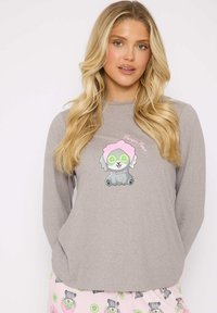 Gray long-sleeve top with a cartoon dog design featuring pink accents and cucumber slices over its eyes, paired with pink pants with similar patterns.