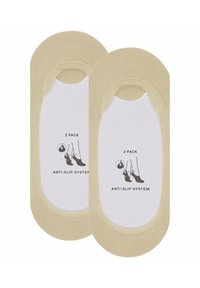 Beige Antirutsch-Sockeneinlagen im Zweierpack, mit glatter Textur und runder Form, versehen mit einem gedruckten Pflegeetikett in Weiß und Schwarz.