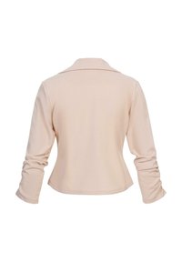 Beige top s dlouhým rukávem, měkkou texturou, přiléhavým střihem a límcem. Jednoduchý design se zřasenými rukávy a hladkým povrchem.