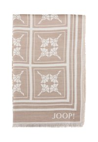 Beige geweven deken met witte geometrische patronen en franjeranden. Bevat JOOP! branding in een subtiele lettertype. Rechthoekige vorm.