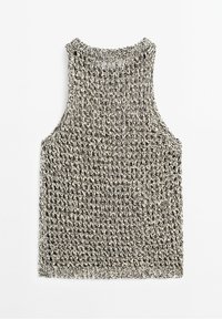Haut sans manches tricoté noir et blanc avec un motif texturé et un col rond, posé à plat sur un fond blanc.