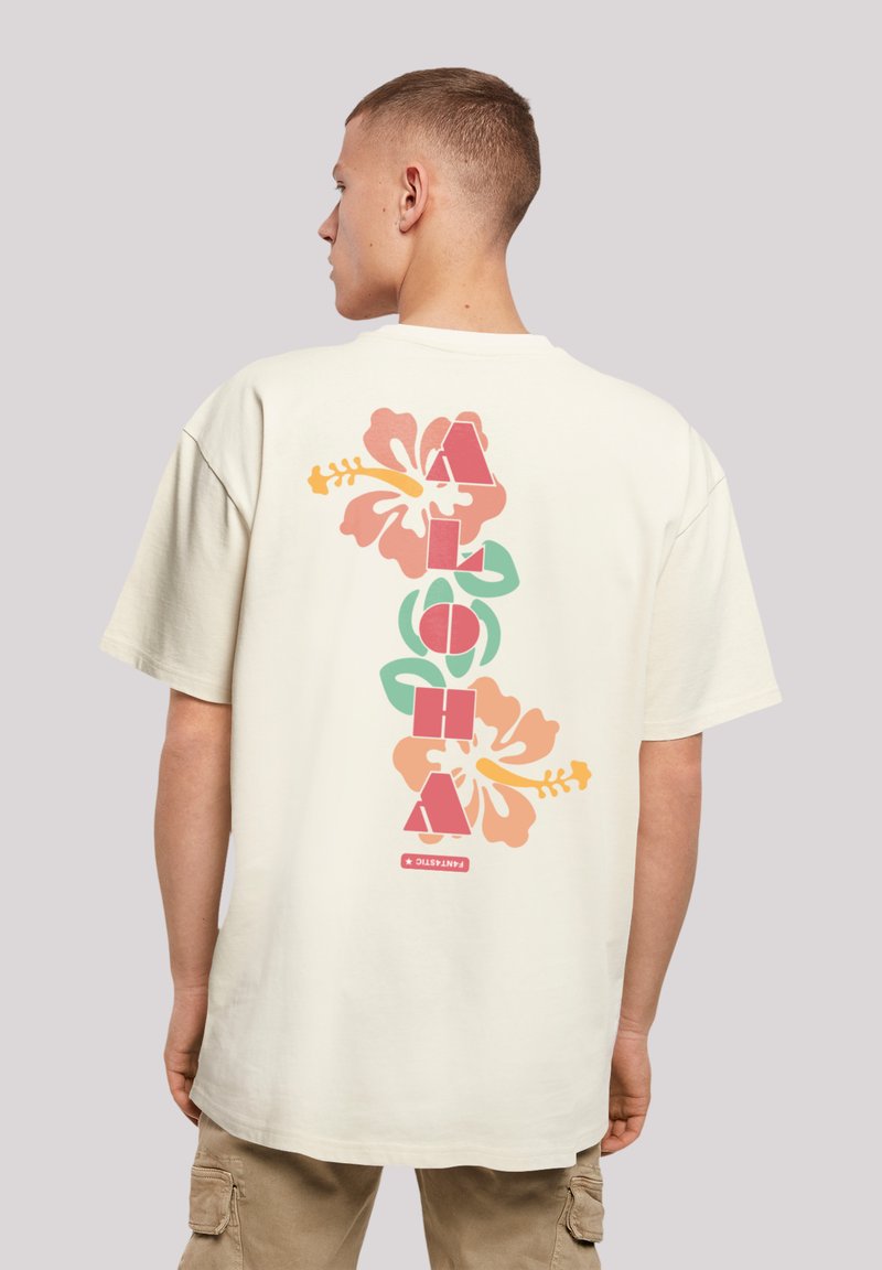 Beige cotton T-shirt featuring a colorful floral design and "ALOHA" text on the back, with pink, green, and orange accents.