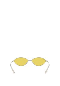 Žlutě filtrové oválné sluneční brýle s tenkými stříbrnými kovovými rámy a průhlednými stranami. Disponují elegantním, minimalistickým designem.