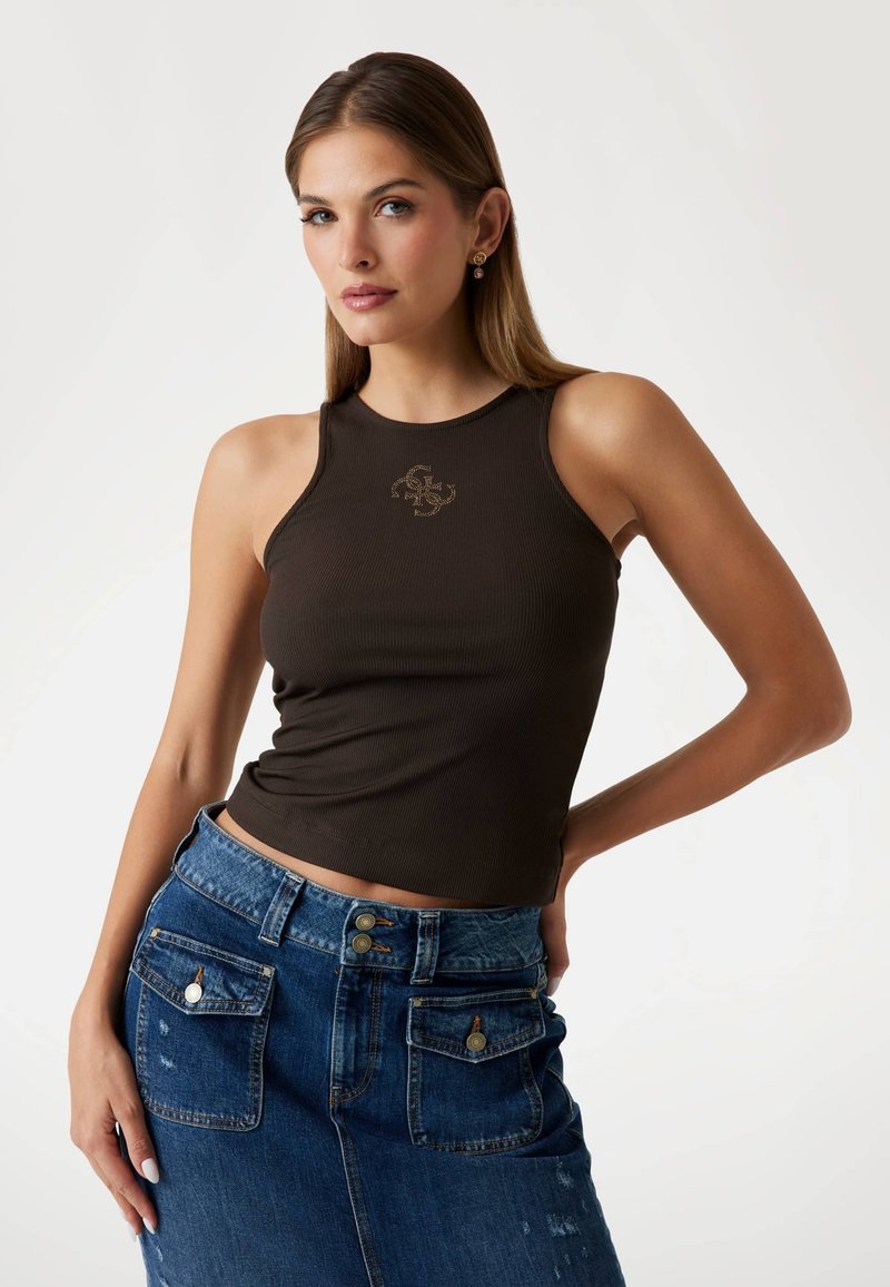 Brown ribbed crop top with a round neckline and logo, paired with a high-waisted blue denim skirt featuring pockets and brass hardware accents.