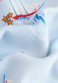 Svetlomodrá látka s námorným vzorom, na ktorom sú člny, vlny a oranžové hviezdy, vykazujúca jemnú textúru a subtilný tkaninový vzor.
