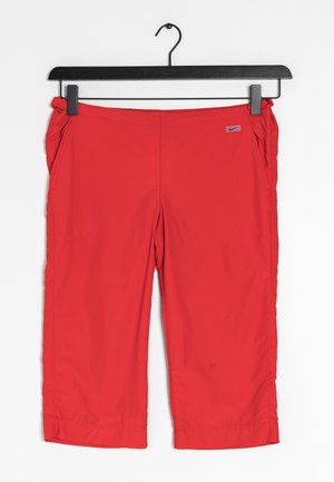 Red athletic capri pants with a slight sheen, elastic waistband, and side pockets. Features a small gray Nike logo on the front.