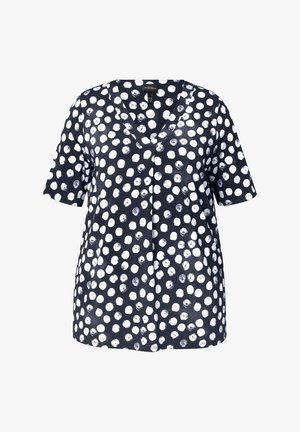 Haut bleu marine avec des motifs circulaires blancs, manches courtes, décolleté en V et coupe décontractée. Fabriqué en tissu léger.