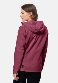 Waterproof maroon jacket with a hood, side pockets, adjustable cuffs, and a small logo tag near the hem. Smooth, matte texture.