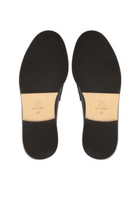Black leather insoles with a smooth texture, featuring a beige leather accent with "KS REAL LEATHER" and size "37" stamped on the underside.