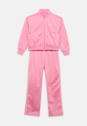 Rosa to-delt treningsdress med glidelåsjakke og elastiske mansjetter, med hvit piping og små Champion-logoer på bryst og erme.