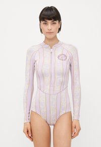 Purple long-sleeve wetsuit features a zip front, wave pattern, gold accents, and a round logo on the chest. Smooth texture and fitted design.
