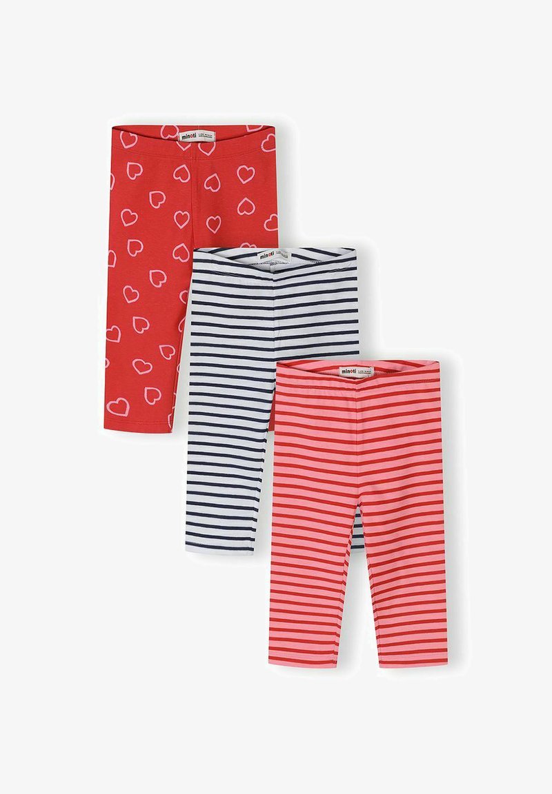 Trois paires de leggings pour tout-petits, une rouge avec des cœurs blancs, une blanche avec des rayures noires, et une rose avec des rayures rouges, étalées à plat.