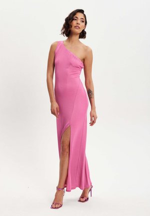 Pink, one-shoulder maxi dress with a side slit, made of a smooth, shiny fabric. Features a fitted silhouette and floor-length hem.