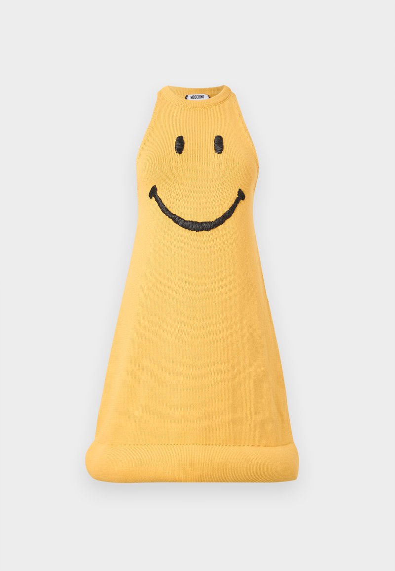 Yellow sleeveless knit dress with black embroidered smiley face on the front and a rolled hem, Moschino brand label visible inside collar.