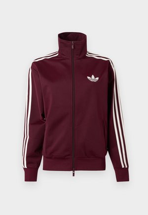 Vinrød lynlåstræningstrøje med hvid Adidas-logo på brystet og tre hvide striber ned langs hver ærme og manchetter.