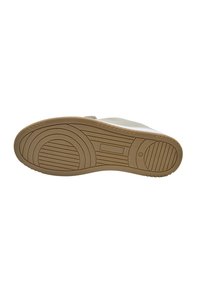 Shoe sole featuring a textured rubber bottom, light tan color, with circular and linear tread patterns for grip and durability.