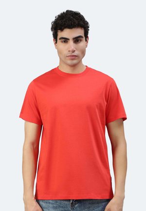 T-shirt in cotone rosso con collo a giro e maniche corte. Design semplice, vestibilità dritta, senza motivi né decorazioni.