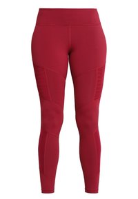 Czerwone legginsy z rozciągliwego materiału, z wysokim stanem, detalami w postaci paneli oraz teksturowanym wzorem po bokach.
