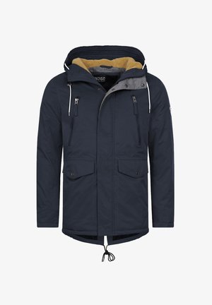 Tummansininen parka-takki, jossa on turkisvuorinen huppu, kaksi vetoketjullista ja kaksi nepparitaskua, kiristysnaru helmassa ja harmaa sisävuori. Vesitiivis materiaali.