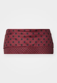 Bandeau en tissu stretch bordeau avec des pois noirs alternés. Texture lisse avec un design ajusté et un motif d'ourlet superposé.