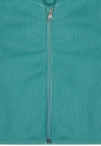 Tealfarbene Zip-Jacke aus strukturiertem Stoff mit einem durchgehenden Reißverschluss und einem runden Ausschnitt, geeignet für legere Anlässe.