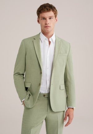 Light green linen blazer with notched lapels and two front pockets, paired with a white button-up shirt. Slim-fit design, smooth texture.