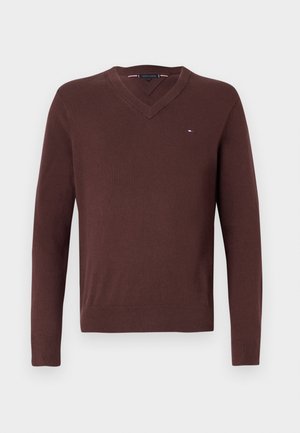 Brown knitted v-neck sweater with long sleeves and ribbed cuffs. Features a small logo on the chest and a smooth texture.