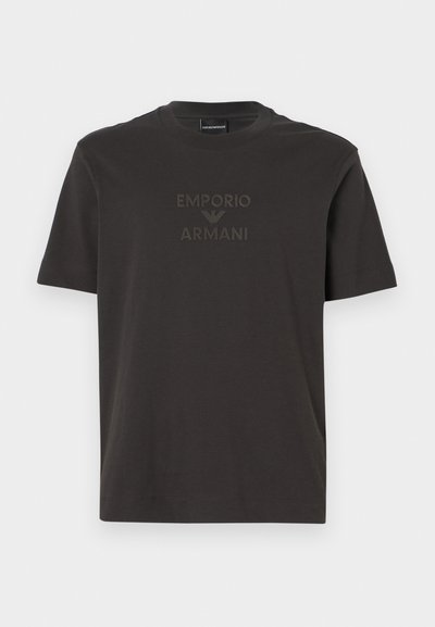 Dark grey cotton t-shirt featuring a crew neck, short sleeves, and a raised logo print in the center reading "EMPORIO ARMANI."