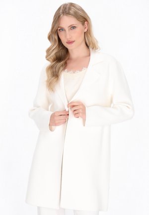 Cappotto bianco in lana con colletto a risvolto, chiusura con un bottone, maniche lunghe e vestibilità rilassata. Texture liscia e design minimalista.
