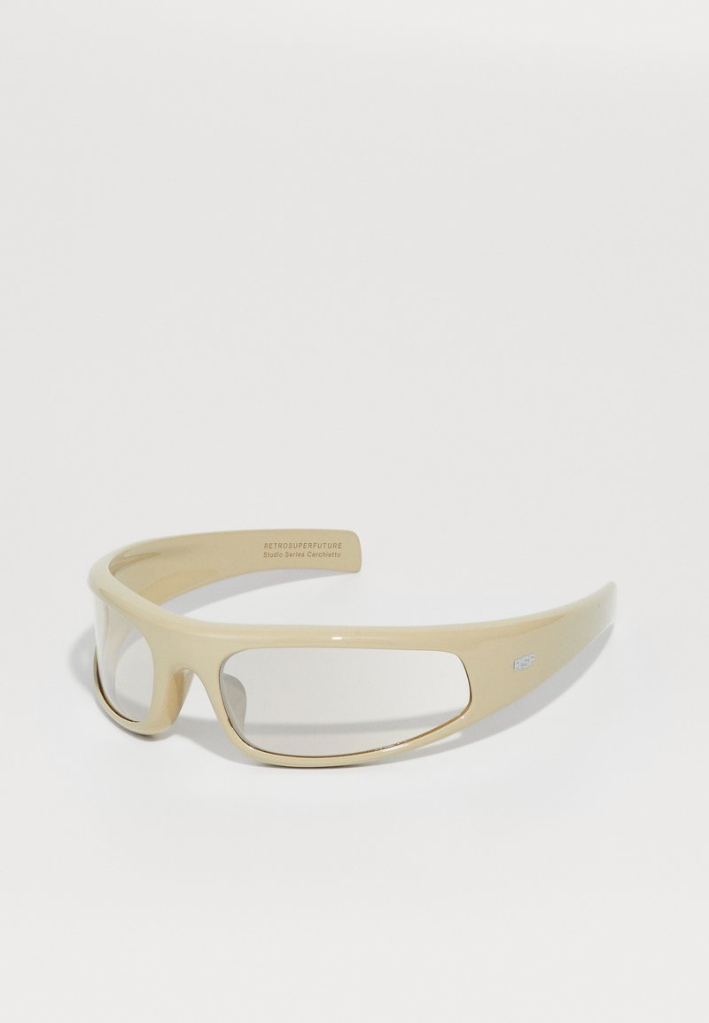 Óculos de sol bege com um design elegante, apresentando grandes lentes recortadas e um acabamento brilhante. Inclui a marca "RSF" na lateral.