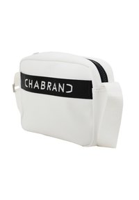 Borsa a tracolla bianca realizzata in materiale liscio, con una tracolla nera su cui è stampato "CHABRAND" in testo bianco e chiusura con zip. Design compatto.