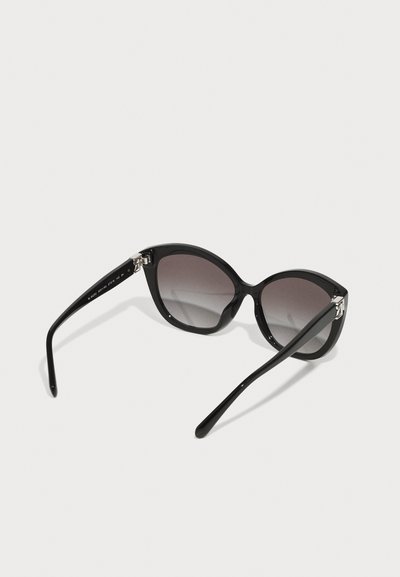 Black cat-eye sunglasses with gradient lenses, glossy finish, and metallic accents at the hinges. Curved, sleek design with elongated arms.