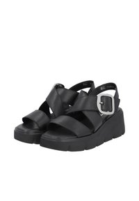 Sandales à plateforme noires avec de larges brides en cuir, une boucle carrée en argent et une semelle épaisse avec une surface texturée.