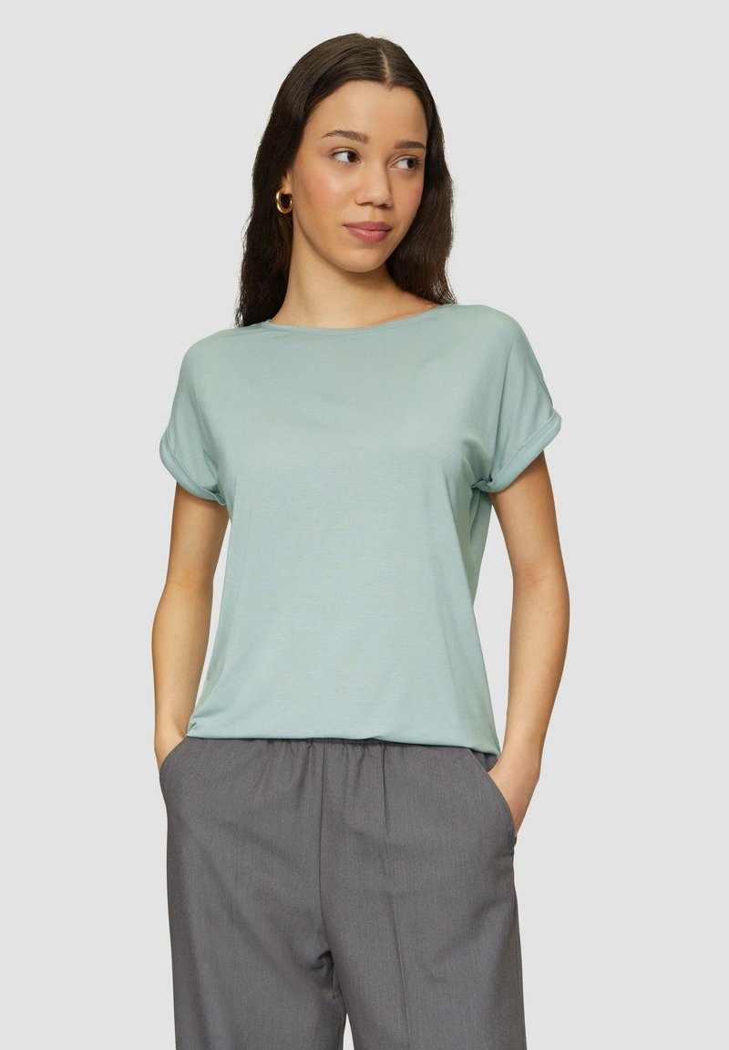 Lichtblauwe t-shirt met korte mouwen en een losse pasvorm, voorzien van opgerolde mouwen en een zachte, gladde textuur, gecombineerd met grijze broek met elastische taille.