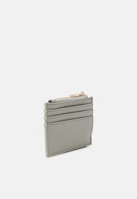 Gray synthetic card holder with five card slots and a zippered compartment. Smooth texture with minimal stitching and gold-tone hardware accents.