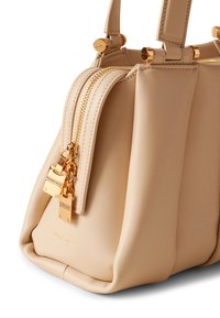 Beige Lederhandtasche mit strukturiertem Design, doppeltem Reißverschluss, goldfarbenen Hardware-Akzenten und geprägten Details am Reißverschluss.