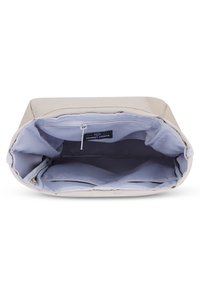Beige fabric bag interior with light blue lining, includes a zipped pocket and multiple compartments for organization. Johnny Urban label visible.