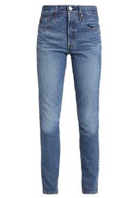 Vaqueros de tiro alto y corte slim en denim de lavado claro, con cinco bolsillos, trabillas para cinturón y bragueta clásica con botones, con un sutil efecto desgastado.