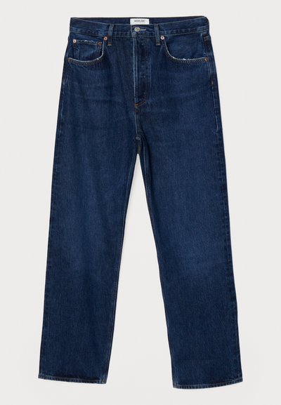 Jeans de denim azul escuro com cintura alta, corte reto, design de cinco bolsos e costuras contrastantes. Apresenta um fecho de botão e passantes para cinto.