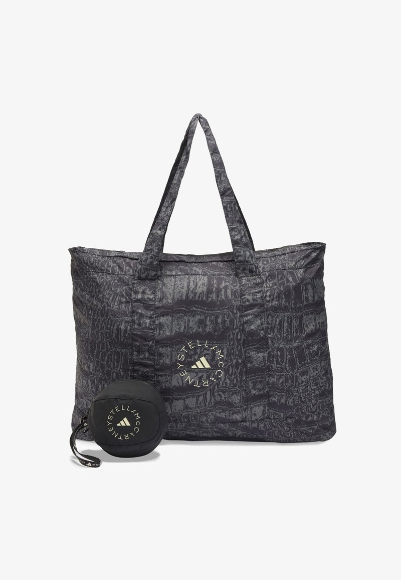 Melnas krokodila raksts auduma iepirkuma soma ar divām rokturiem un logotipa uzlīmi. Iekļauta kompaktā, noņēmamā maki saderīgā melnā krāsā.