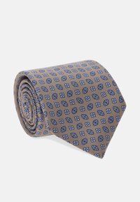 Hnedá vzorovaná kravata stočená do spirály, s modrými a bielymi tvarmi a kontrastnými akcentmi. Hladká textura, vyrobená z látky.