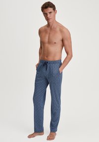 Navy blauwe loungbroeken met een geometrisch patroon, lichtgewicht stof, elastische tailleband met trekkoord en zijzakken.