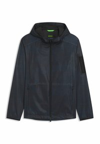 Men's navy windbreaker jacket in lightweight, textured fabric. Features a hood, front zipper, side pockets, and a zippered sleeve pocket.