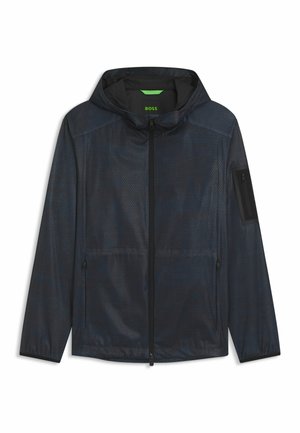 Men's navy windbreaker jacket in lightweight, textured fabric. Features a hood, front zipper, side pockets, and a zippered sleeve pocket.