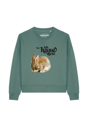Green sweatshirt with a relaxed fit, featuring a graphic of a resting rabbit and the text "ich hasse dich!" in stylized black font.