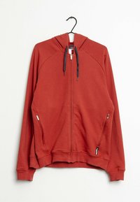 Red zip-up hoodie with a front zipper and side pockets. Features a hood, raglan sleeves, and contrasting drawstrings. Soft material and textured finish.