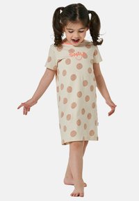 Abito di cotone beige chiaro con pois marroni e testo "SORRIDI" in corallo. Maniche corte e vestibilità rilassata, che arriva a metà polpaccio.