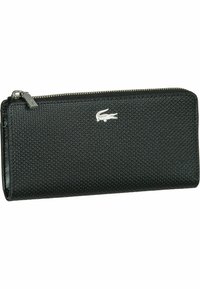 Portafoglio nero con zip a giro realizzato in materiale testa di moro, caratterizzato da un delicato motivo in rilievo e un accento con logo di coccodrillo argentato.
